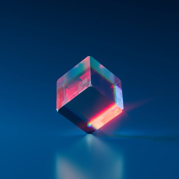 Image of a transparent cube with a red reflection on the bottom right (on the edge) and a large reflection on the left side. The cube is at 45 degrees horizontally and vertically. That is, only 3 faces are visible (bottom, right and left)