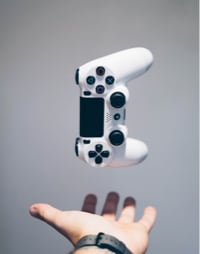 Image of a person with their left hand outstretched with a controller falling down, or one that has just been thrown up